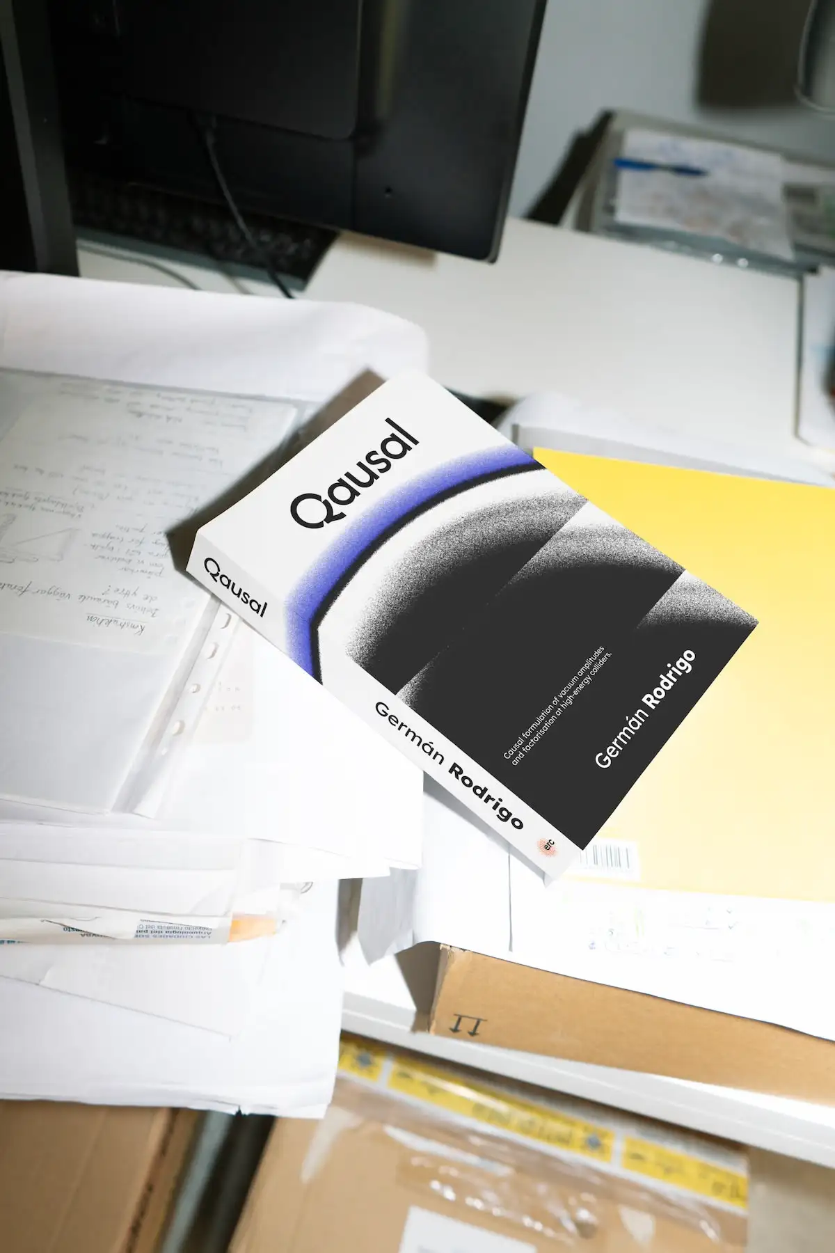 Mockup of a book name 'Qausal' with the logo on the front, written by Germán Rodrigo